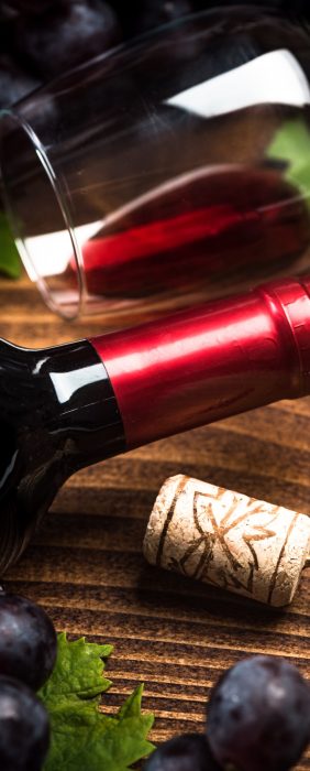 Bottle of red wine with corkscrew.