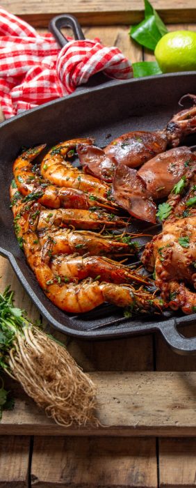 Grilled spimps, squids and octopus in cast iron grill pan.